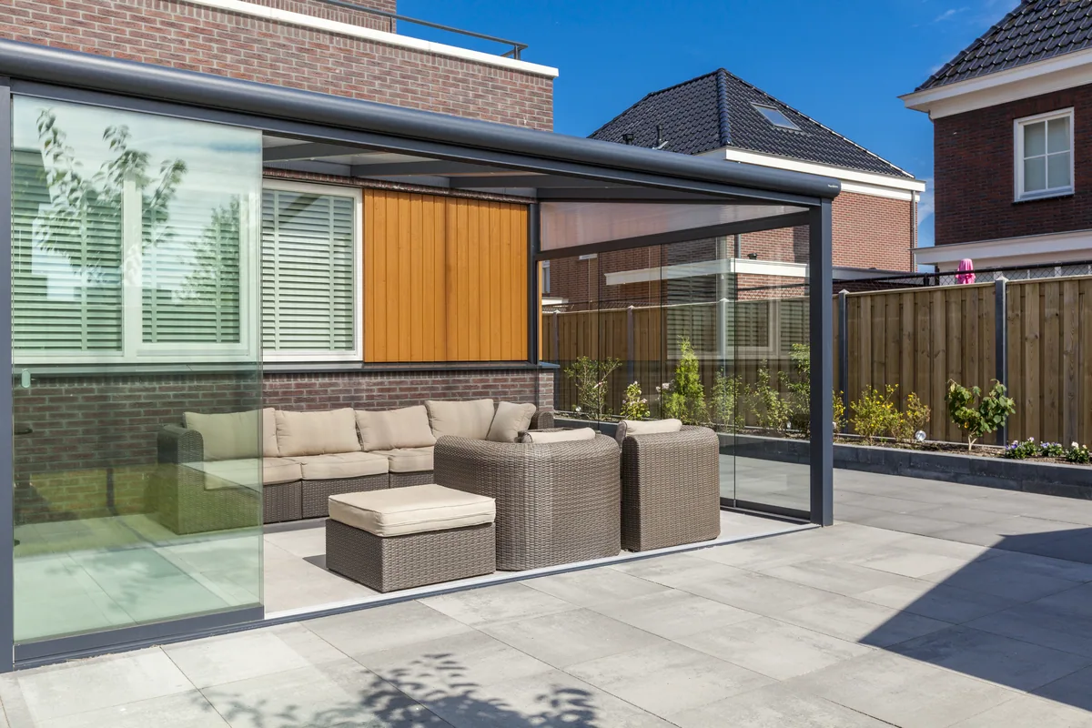 Outdoor lounge seating under a wall mounted Bosco veranda